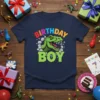 Birthday Boy Dinosaur T-Shirt with a green T-Rex bursting through rocks, colorful text