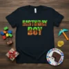 Birthday Boy text in pixelated, blocky font inspired by building video games on a black t-shirt