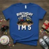 Birthday Boy I'm 5 text with red and yellow monster trucks and checkered flags on a blue t-shirt for a