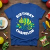 Blue t-shirt with "BIRTHDAY CHAMELON" text and a cartoon chameleon wearing a party hat, surrounded by confetti
