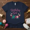 Birthday Girl text with floral wreath graphic on a navy blue t-shirt