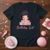 Birthday Girl text with a cute teddy bear on a pile of presents, pink confetti, on a black t-shirt