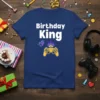 Birthday King Level Up text with a golden video game controller and crown graphic on a navy blue t-shirt