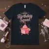 Birthday Squad text with crown and cupcake graphic on a black t-shirt, perfect for birthday parties