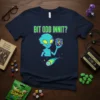 Blue t-shirt with green text "BIT ODD INNIT?" above a turquoise alien holding a Rubik's Cube and a comet graphic