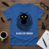 Black cat with yellow eyes centered in a swirling cosmic design, text "BLACK CAT ENERGY" below, on a blue t-shirt