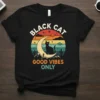 Black Cat Good Vibes Only retro sunset t-shirt design with a black cat on a crescent moon