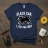Black cat silhouette with stars and "Black Cat Lives Matter" text on a navy blue t-shirt