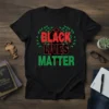 Black t-shirt with red and green "BLACK LIVES MATTER" text and a raised fist graphic surrounded by green leaves