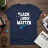 Black Lives Matter text with a purple and white raised fist graphic and colorful waves on a navy blue t-shirt