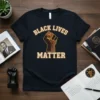 Black Lives Matter t-shirt with raised fist graphic and bold text in yellow and brown