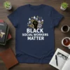 Black Social Workers Matter text with a raised fist graphic and gears, on a navy blue t-shirt