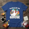 Funny Blame It On The Goose T-Shirt with a cartoon goose wearing sunglasses and pointing, surrounded by chaos