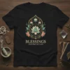 Black t-shirt with "Blessings and Protection" text and intricate lotus floral mandala design in gold, teal, and coral colors