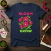 Bloom Grow t-shirt design with pink flowers and green leaves, featuring bold pink and green text
