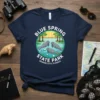 Blue Spring State Park Orange City Florida t-shirt design featuring three manatees swimming in water with trees and a boardwalk