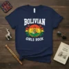 Navy blue t-shirt with "BOLIVIAN GIRLS ROCK" text and a circular design featuring the Bolivian flag, eagle, and books