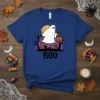 Bigfoot dressed as a ghost saying BOO with a pumpkin bucket, on a blue t-shirt, Halloween theme