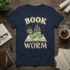 Book Worm T-Shirt featuring a cute green caterpillar wearing glasses on an open book with a castle graphic and stars