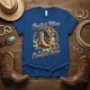 Boots & Bling it's a Cowgirl Thing text with cowboy boots and hat graphic on blue t-shirt