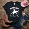 Black t-shirt with "BOOTS & BLING It's a Cowgirl Thing" text and a silhouette of a cowgirl riding a horse