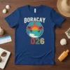 Boracay 2026 text with a retro sunset beach graphic, palm trees, and sunglasses on a blue t-shirt