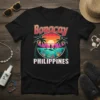Boracay Philippines text with sunset paddleboarding scene, palm trees, and ocean life graphic on a black t-shirt