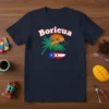 Boricua t-shirt design with a coqui frog on a palm tree, Puerto Rico flag map, and sunset graphic