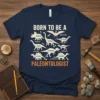 Born To Be A Paleontologist T-Shirt with various dinosaur illustrations and labels, including Triceratops and Tyrannosaurus Rex