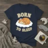 Born to Sleep t-shirt design featuring a cute orange tabby cat sleeping on a cloud with text above and below