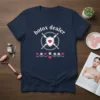 Navy t-shirt with "botox dealer" text, crossed syringes, shield with heart, and floral accents