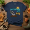 Navy t-shirt with the text "BOTTOM HOE GETS dirty" and a graphic of three shovels in dirt, smiling sun above