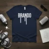 Navy blue t-shirt with the white text "BRANDO" in a dripping font, featuring stylized lines below the letters