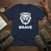 Navy blue t-shirt with a white geometric lion head graphic and the word "BRAVE" below it