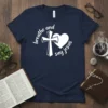Navy blue t-shirt with white text "breathe and say jesus" encircling a cross and heart graphic