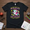 First grade t-shirt design featuring a unicorn, rainbow, school bell, books, and the text "Bring On The Magic 1st Grade
