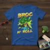 Broc N' Roll t-shirt design with a cartoon broccoli character playing a blue electric guitar and making a rock hand