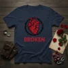 Navy blue t-shirt with a red anatomical heart surrounded by black thorns and the word BROKEN in red text