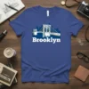 Brooklyn Bridge graphic with NYC skyline and text "Brooklyn" on a blue t-shirt