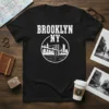 BROOKLYN NY text with circular Brooklyn Bridge skyline graphic on a black t-shirt