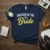 Brother of the Bride text with wedding rings graphic on a navy blue t-shirt, part of a wedding ensemble