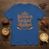 Brown Sugar Babe text with crown graphic on a blue t-shirt, celebrating melanin beauty