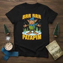 Brr Brr Patapim winter goblin t-shirt with blue hat and scarf, standing in snow, with trees and ice crystals