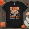 T-shirt design with "BRUH it's FIELD DAY Orange Team" text and cartoon runners, featuring orange and white colors