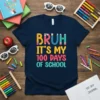 Bruh It's My 100 Days Of School text design with colorful pencil letters, navy blue t-shirt