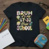 BRUH it's my 67+33 Days SCHOOL text with floral patterns and school icons on a black t-shirt