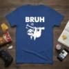 BRUH text above a grumpy white sloth hanging from a tree branch on a royal blue t-shirt