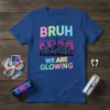 Bruh We Are Glowing text with a retro cityscape graphic, featuring neon colors and an 80s vibe, on a royal