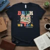 Bruh We Back #librarian text with stacked books and retro glasses graphic on a navy t-shirt