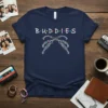 Navy blue t-shirt with "BUDDIES" text in white and colorful dots, featuring crossed braided friendship bracelets design